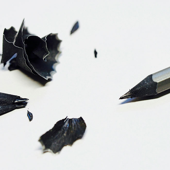 A freshly sharpened pencil surrounded by shavings.