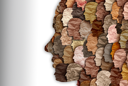 An older man with white hair, wearing a light button-down shirt and a lanyard, appears to be speaking and gesturing with his hands.